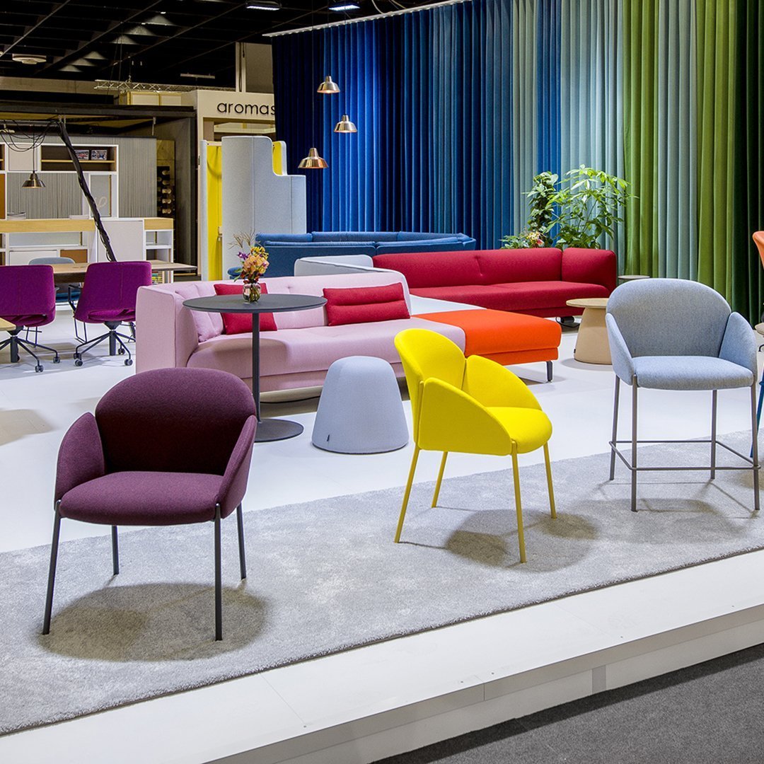 Vibrant seating in purple, yellow, blue, and red hues, featuring modern patterns in a stylish showroom setting.