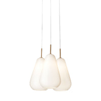 Three elegant white pendant lights with smooth, rounded shapes and subtle gold accents, hanging from clear wires.