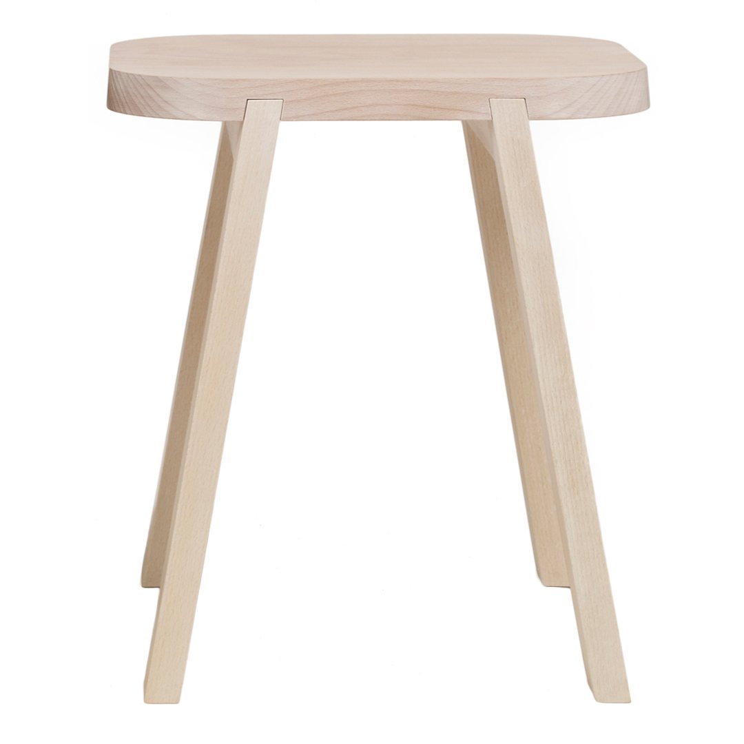 Natural light wood stool with a smooth, minimal design featuring subtle grain patterns and a cream finish.