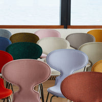 Colorful chairs featuring diverse textures and shades including red, blue, green, pink, and beige patterns.