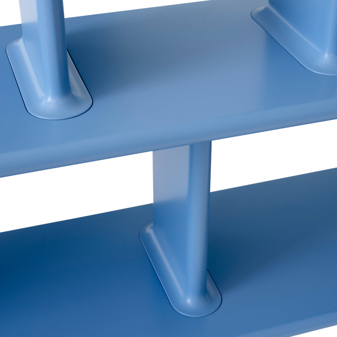 Blue shelving unit with a sleek, minimalist design and smooth, solid blue surfaces.