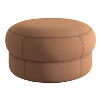 Round ottoman in warm terracotta with subtle stitching and a smooth, textured fabric. Perfect for cozy spaces.