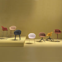 Stylish chairs in shades of pink, brown, yellow, black, and cream against a warm yellow background. Modern design patterns.