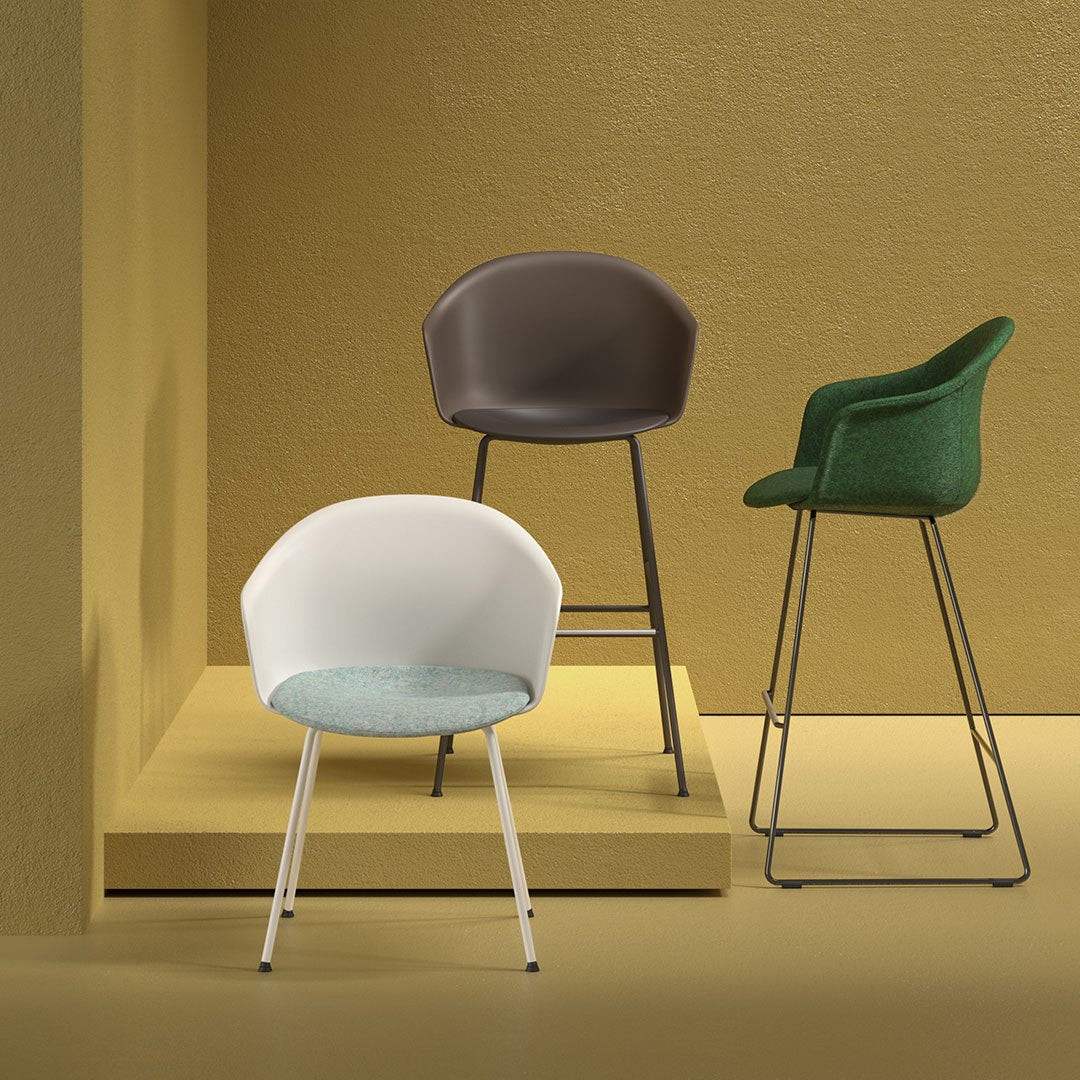 Three stylish chairs in white, brown, and green with sleek patterns against a textured yellow and beige background.