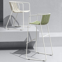 White and green woven bar stools with sleek metal frames, perfect for modern decor.