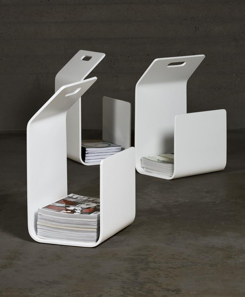 Modern white magazine holders with a sleek design, featuring a minimalist pattern and clean lines. Perfect for organization.