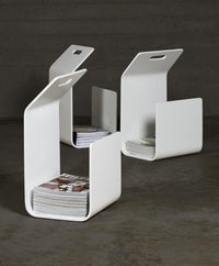Modern white magazine holders with a sleek design, featuring a minimalist pattern and clean lines. Perfect for organization.