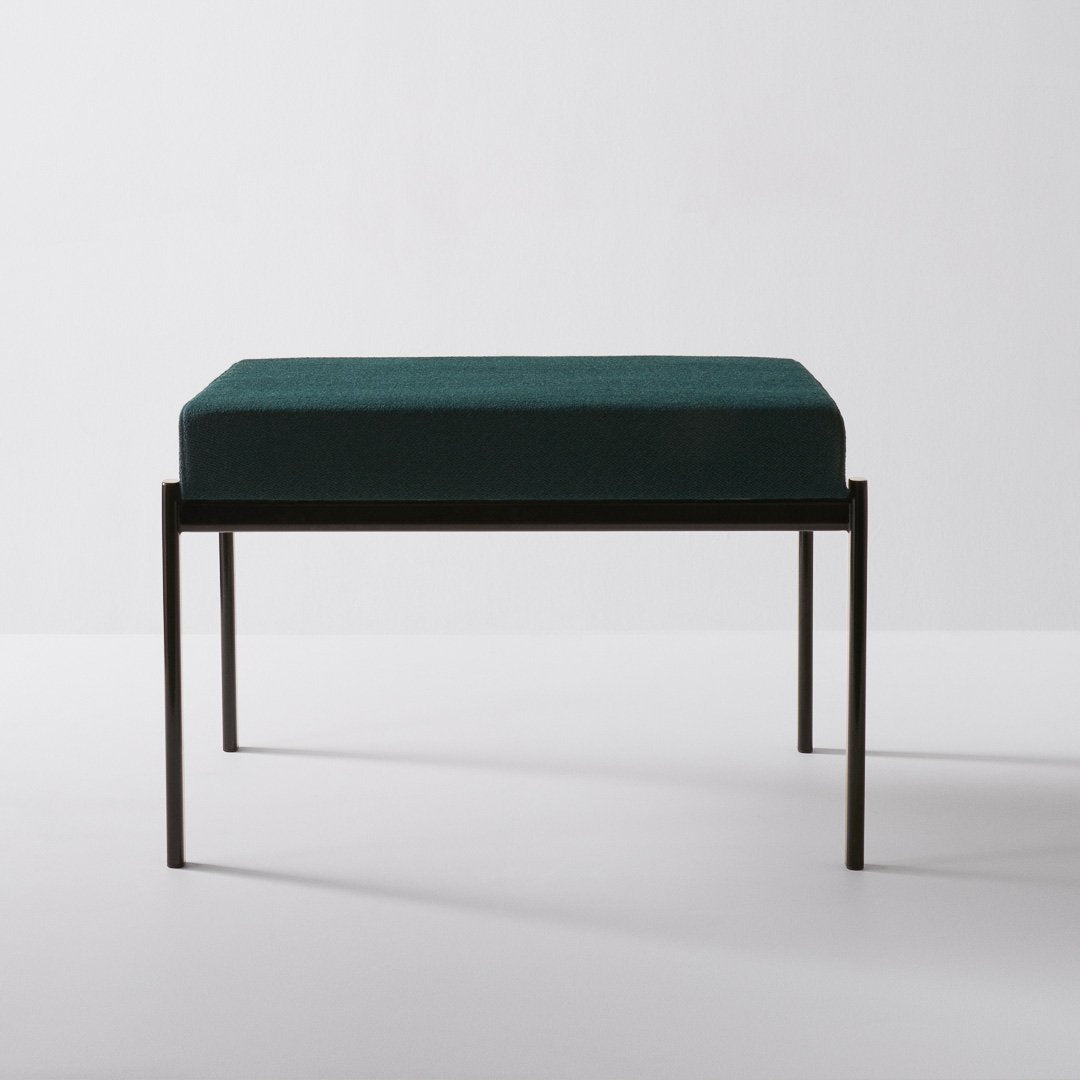 Teal velvet cushion on a sleek black metal frame, featuring a minimalist design for modern decor.