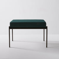 Teal velvet cushion on a sleek black metal frame, featuring a minimalist design for modern decor.