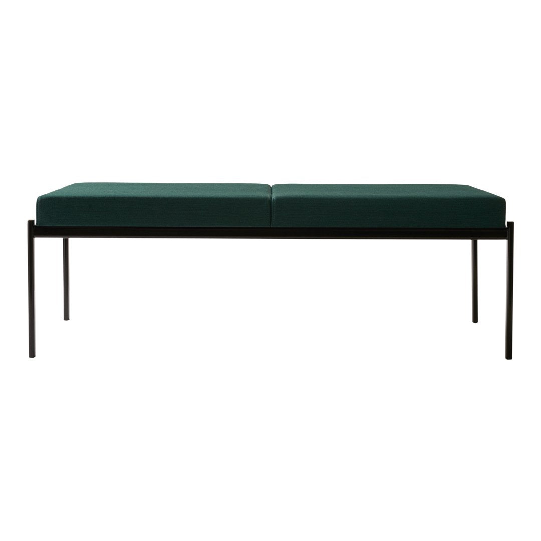 Green upholstered bench with a sleek black metal frame, featuring a minimalist, modern design.