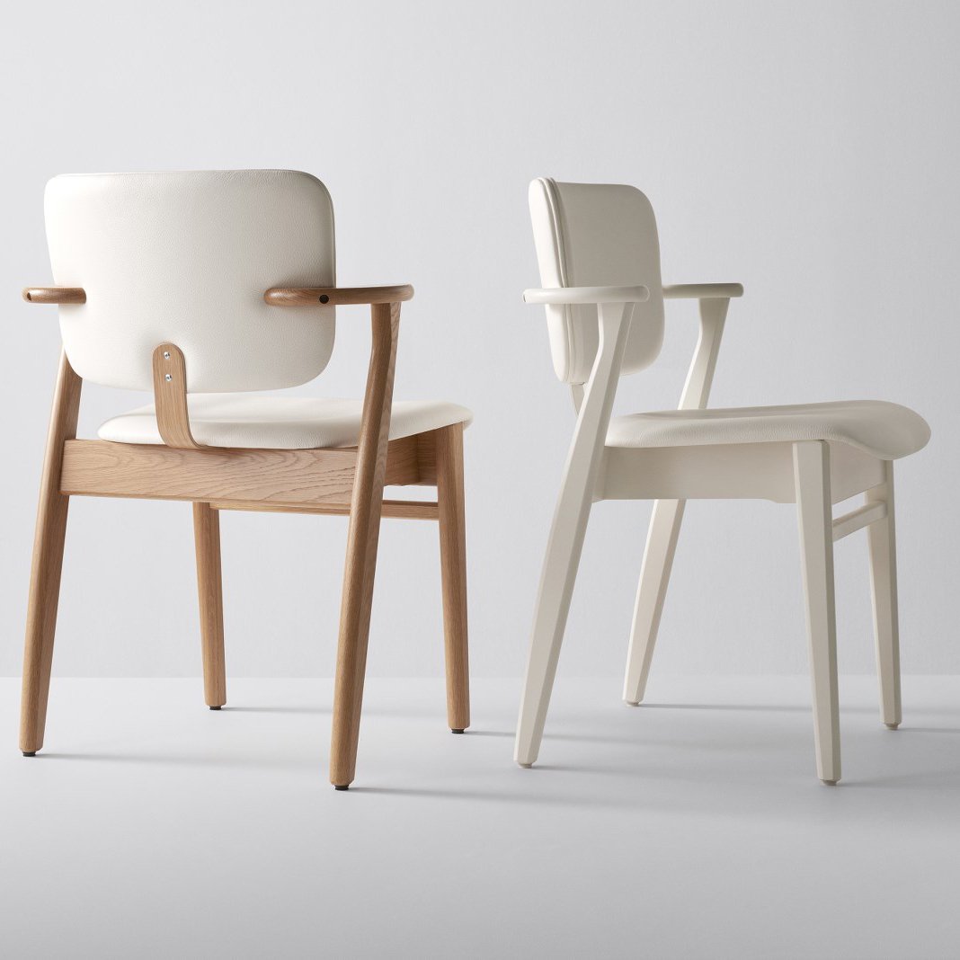 Beige and white modern chairs with wooden armrests, featuring a sleek, minimalist design.