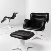 Black leather chair and ottoman with a sleek white base, featuring modern curves and simple lines.