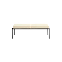 Cream-colored cushioned bench with a sleek black metal frame, featuring a minimalist design. Perfect for modern decor.