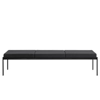 Black minimalist bench with a smooth, sleek design and three cushion sections on a sturdy metal frame.