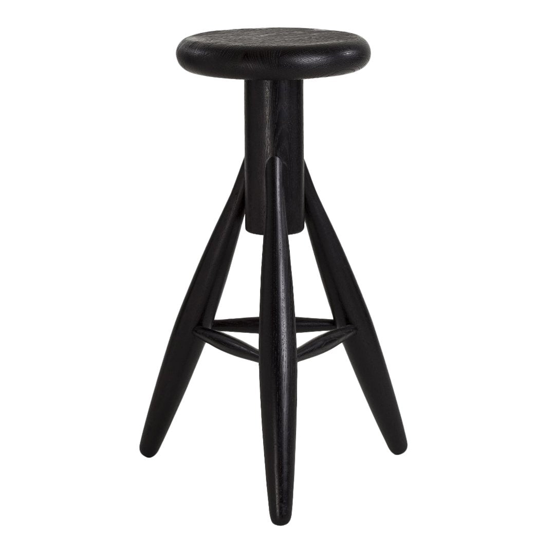 Black wooden stool with a round seat and angular legs, featuring a sleek, minimalist design.
