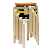 Colorful stacked stools featuring orange, yellow, green, and black patterns with light wooden legs.