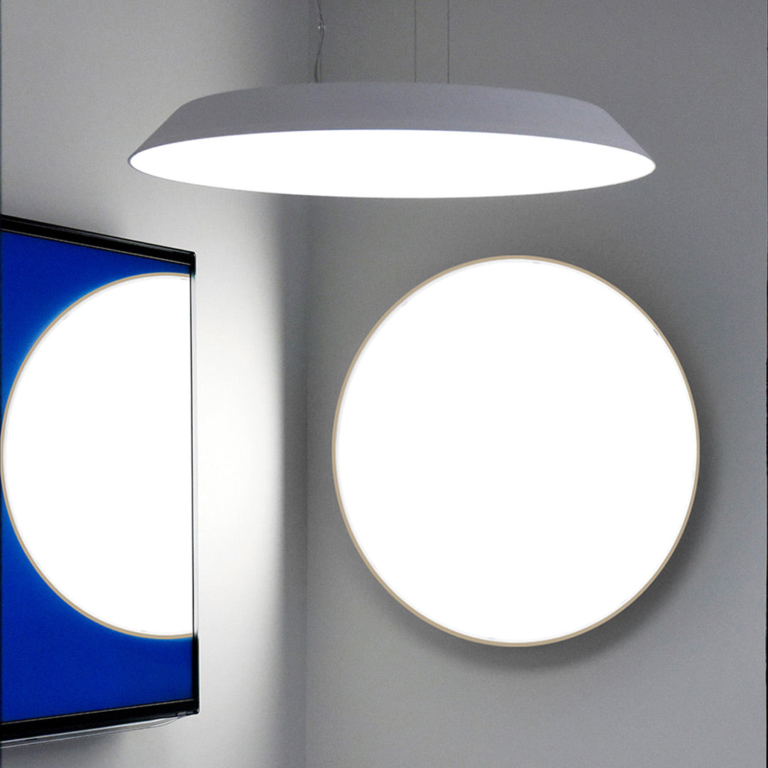 Modern round white pendant light against a minimalist background with blue and white circles.