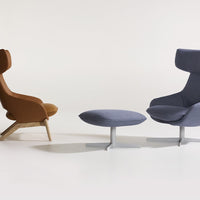 Two modern chairs: one in warm brown upholstery and the other in cool blue fabric, alongside a matching ottoman.