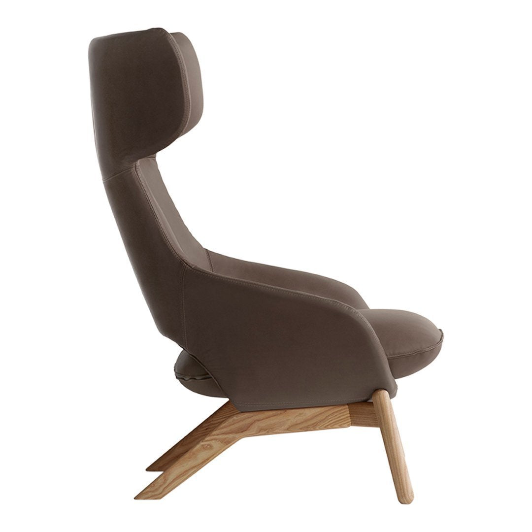 Brown upholstered chair with a sleek design and natural wooden legs, showcasing minimalist style and modern elegance.