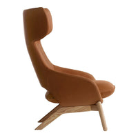 "Side view of a chic, brown velvet chair with a minimalist wooden base, showcasing a smooth, modern design."