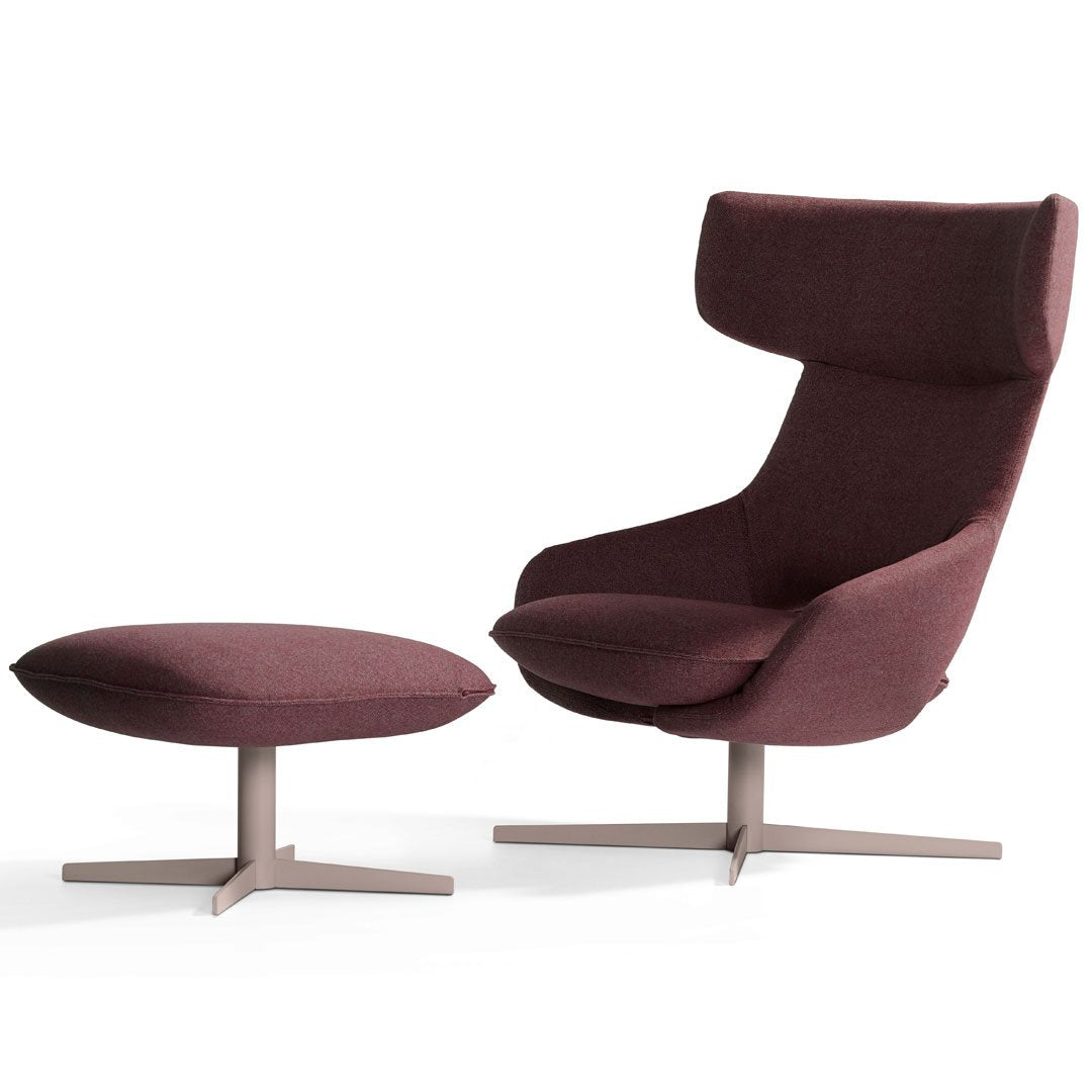 Burgundy upholstered armchair with matching ottoman, featuring a smooth, modern design and sleek metal base.