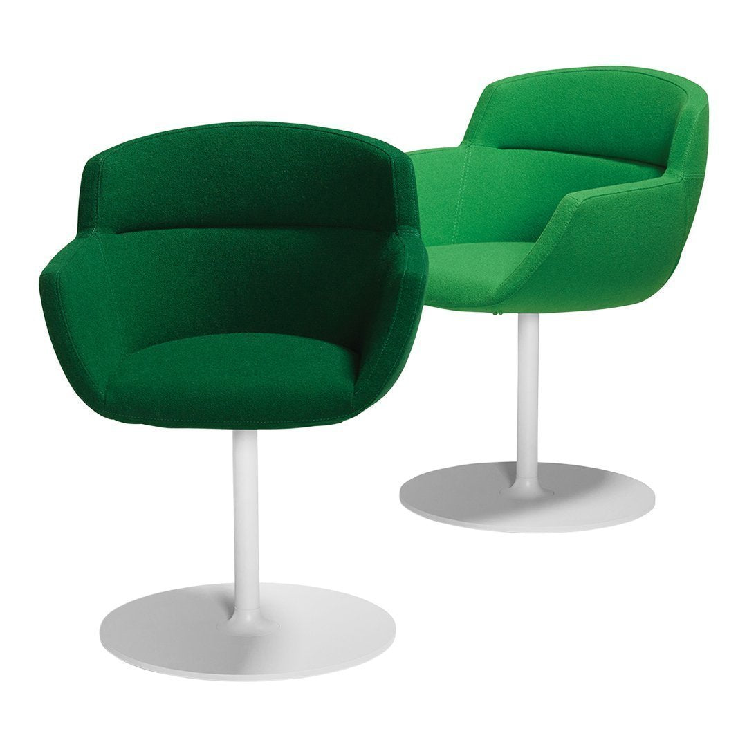 Green upholstered chairs with a smooth, modern design and white bases, perfect for a stylish interior.