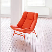 Vibrant orange accent chair with geometric pattern against a light, minimalist backdrop. Ideal for modern decor.