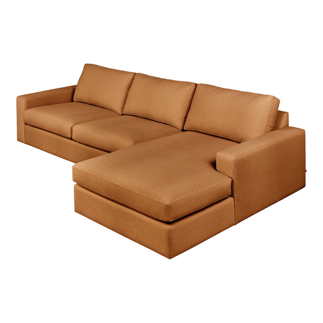 Luxe tan sectional sofa with clean lines and a smooth, textured fabric, perfect for modern living spaces.