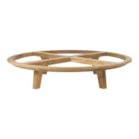 Round wooden coffee table with a natural light brown finish and a simple geometric design.