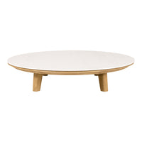 Round coffee table in a smooth white finish with natural wood legs, showcasing a minimalist design.