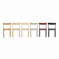 Colorful stackable chairs featuring natural wood, sage green, deep red, and sleek black finishes in a minimalist design.
