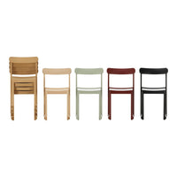 Set of five wooden chairs in natural wood, pale green, red, and black finishes, featuring sleek, minimalist designs.