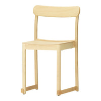 Light wooden chair with a natural finish and simple, smooth lines; no patterns. Ideal for minimalist decor.