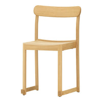 Light natural wood chair with a smooth finish and minimalist design, featuring a simple, solid color.