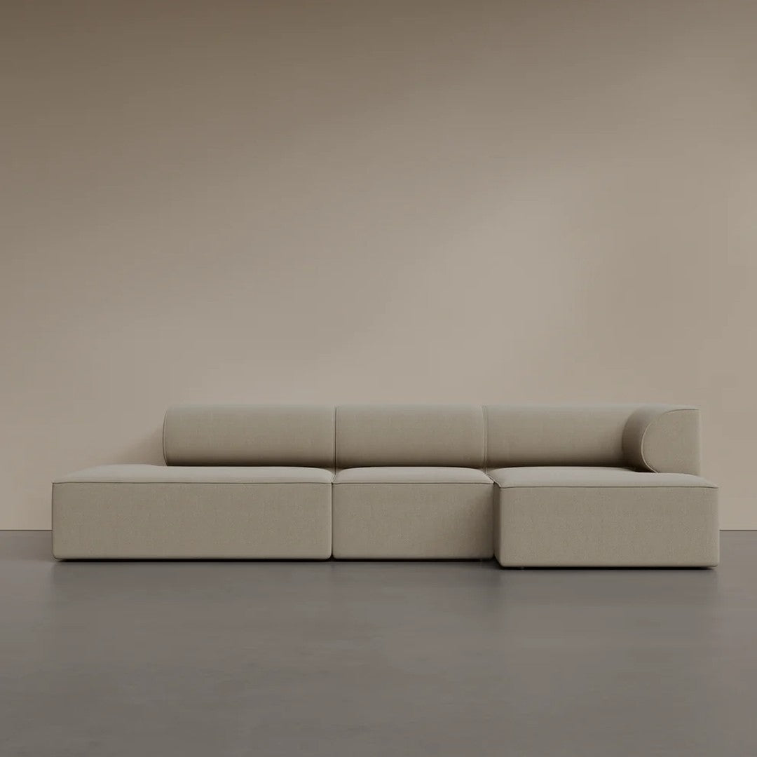 Beige modular sofa with a smooth, minimalist design and clean lines against a neutral backdrop.
