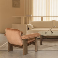 "Modern beige and taupe living room set with soft velvet armchair and sleek glass coffee table, neutral color palette."