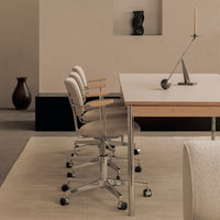 Minimalist office scene featuring beige chairs with subtle stripes, a light wood desk, and soft neutral tones throughout.