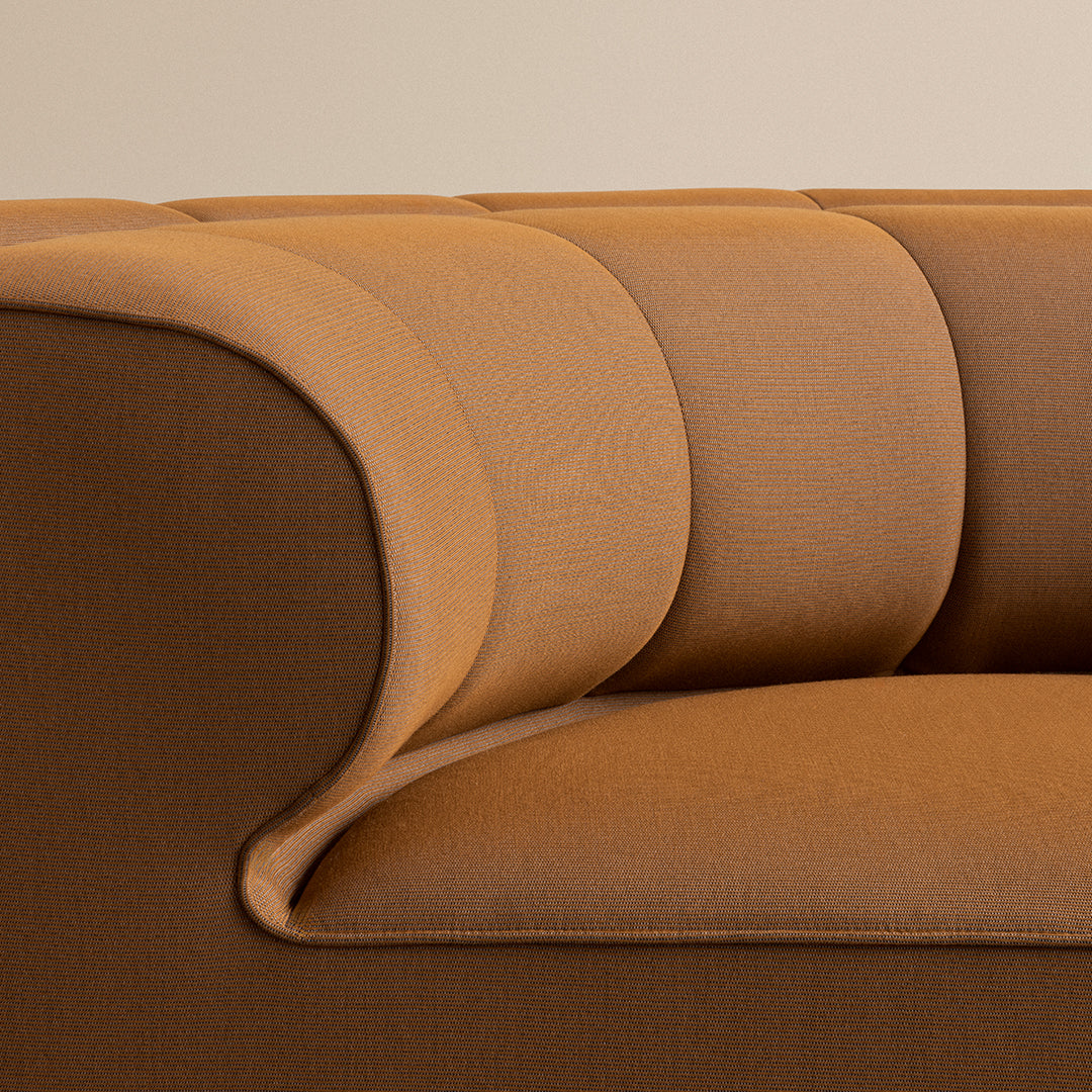 Brown and tan upholstered sofa with a smooth, ribbed texture and curved armrests, adding a modern touch to any space.