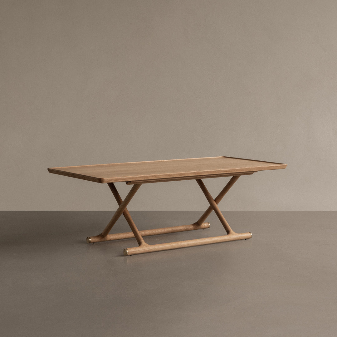 Natural wood finish dining table with a minimalist design, showcasing light beige tones and smooth, sleek lines.