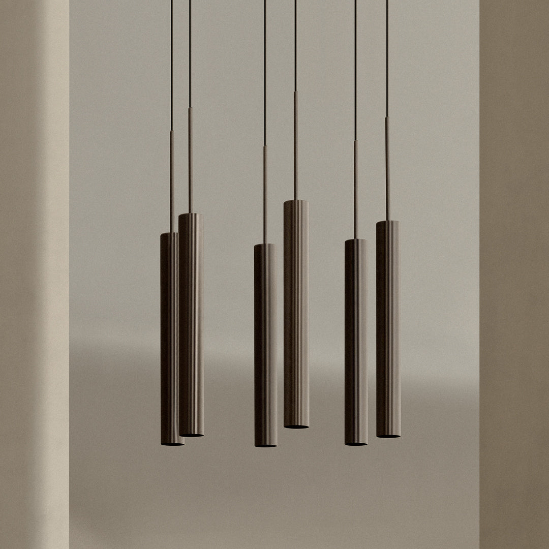 Modern pendant lights with a sleek brown finish and textured cylindrical shades against a neutral backdrop.