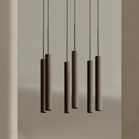Modern pendant lights with a sleek brown finish and textured cylindrical shades against a neutral backdrop.