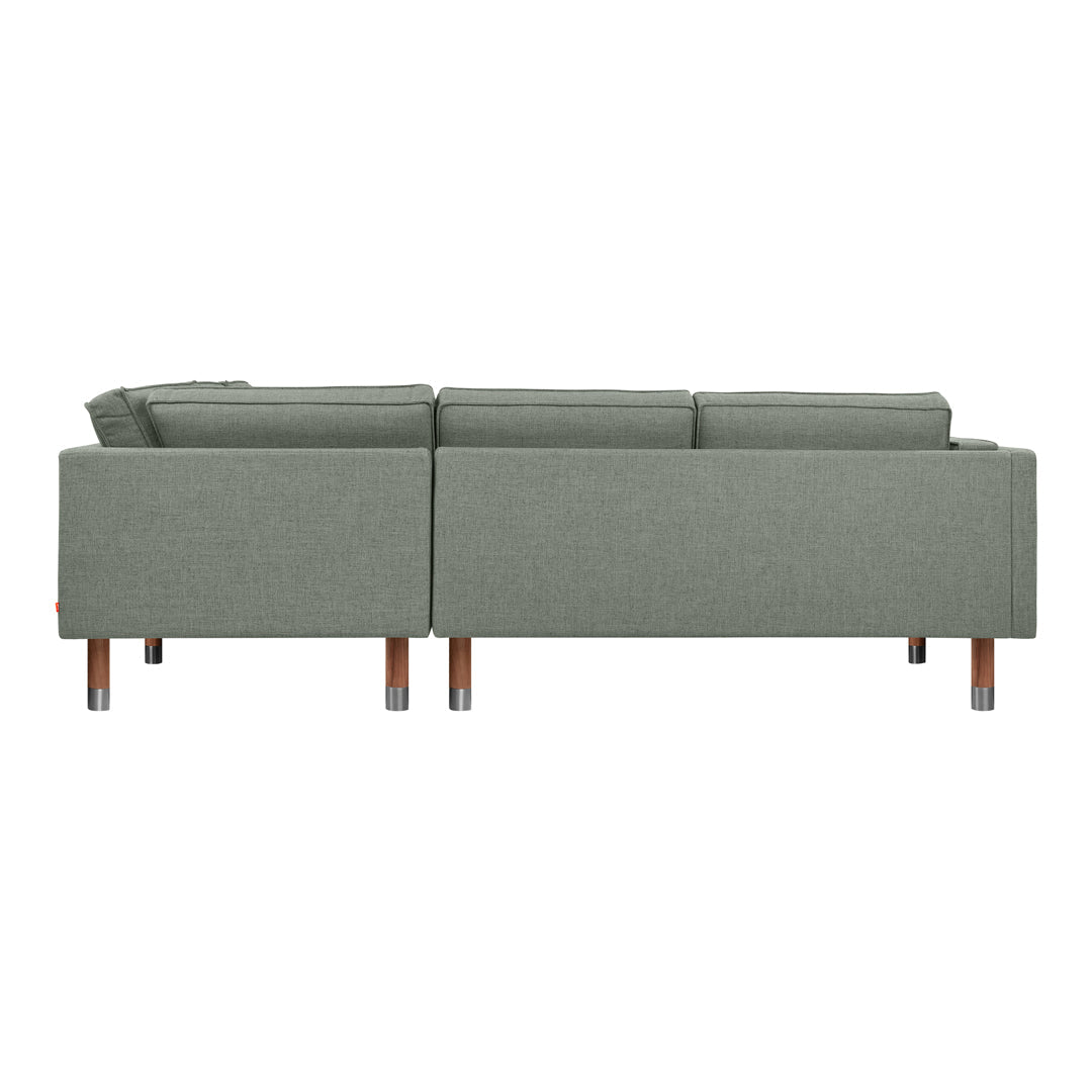 Green fabric sofa with clean lines and wooden legs, showcasing a modern, minimalist design.