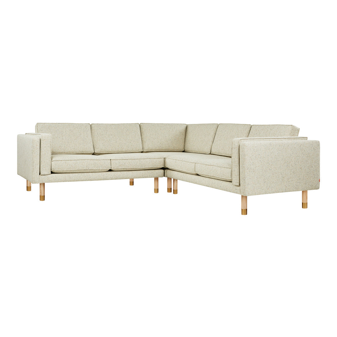 Light beige sectional sofa with a textured fabric and natural wooden legs for a modern, minimalist aesthetic.
