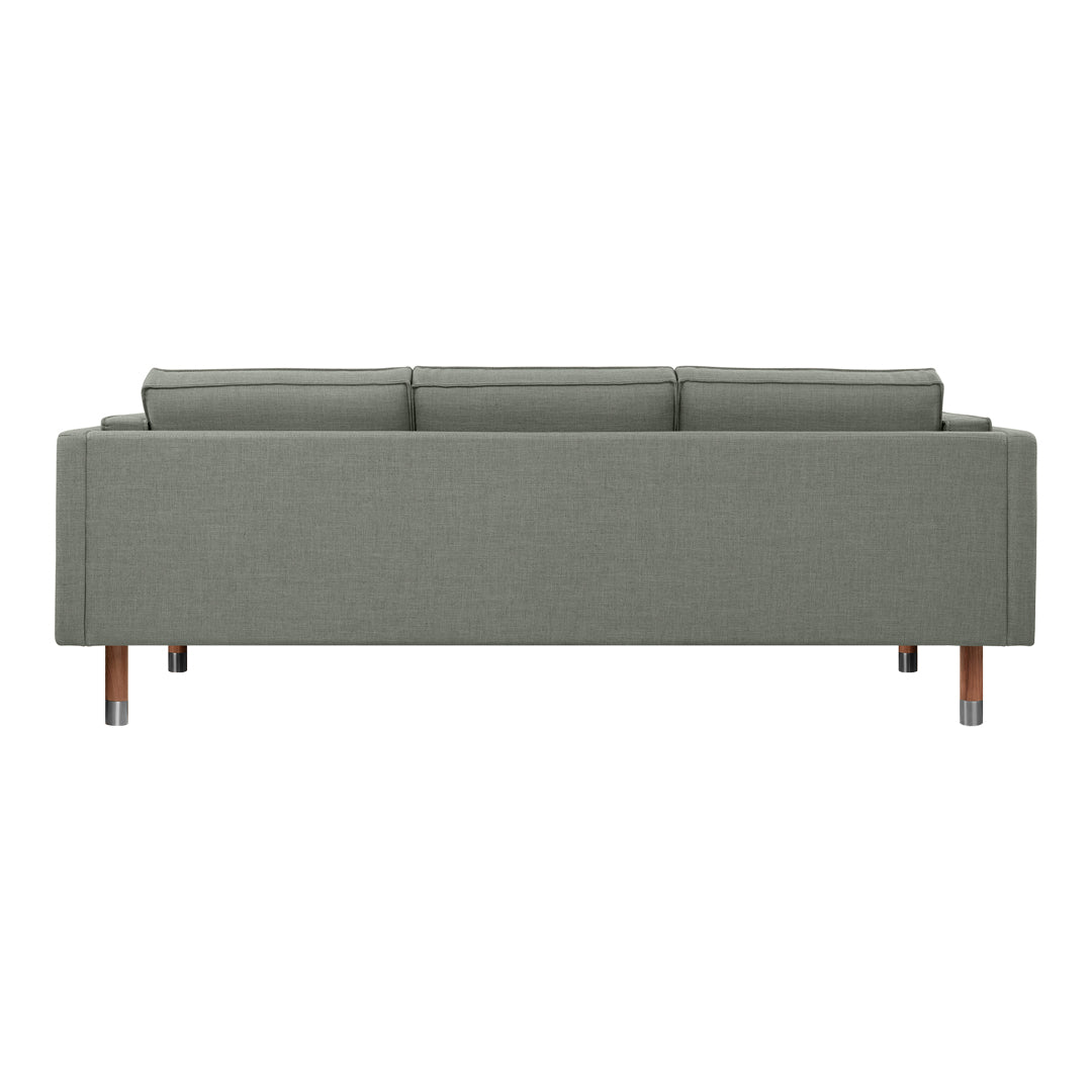 Modern green fabric sofa with a sleek design and wooden legs, featuring a minimalist aesthetic.