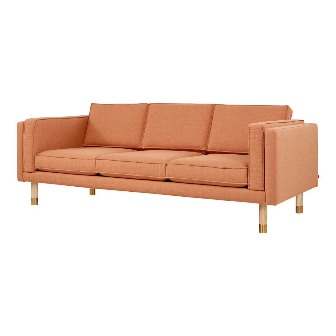 Orange upholstered sofa with clean lines and three cushioned seats, featuring natural wood legs.