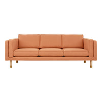Sleek modern sofa in warm peach hue with smooth fabric and wooden legs, perfect for contemporary interiors.