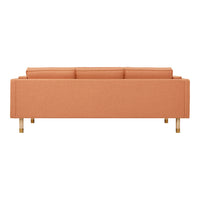 Peach-colored sofa with a sleek design, featuring a simple pattern and golden legs for a modern touch.