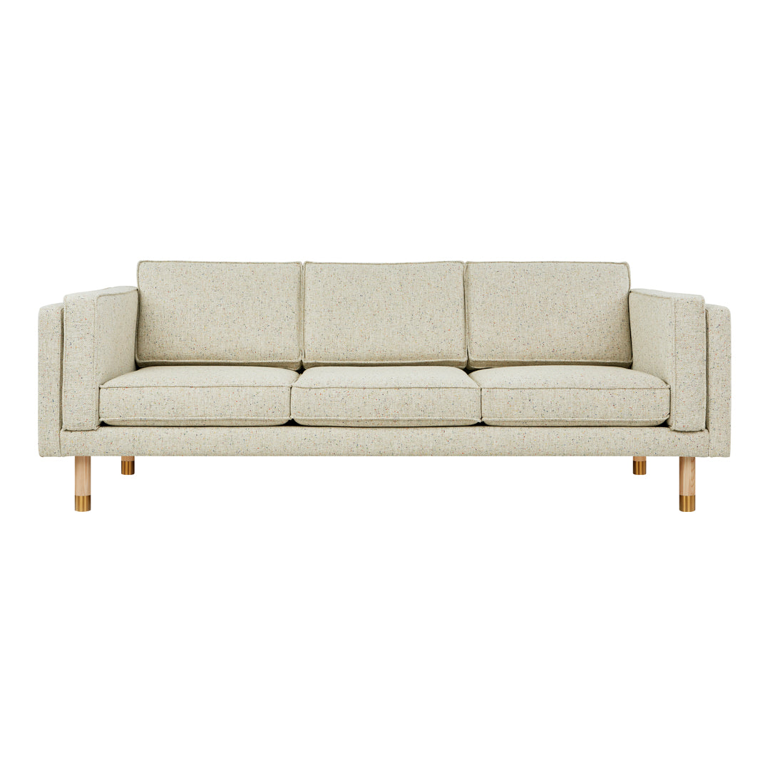 Light beige sofa with a textured fabric and natural wooden legs, featuring a minimalist design and clean lines.