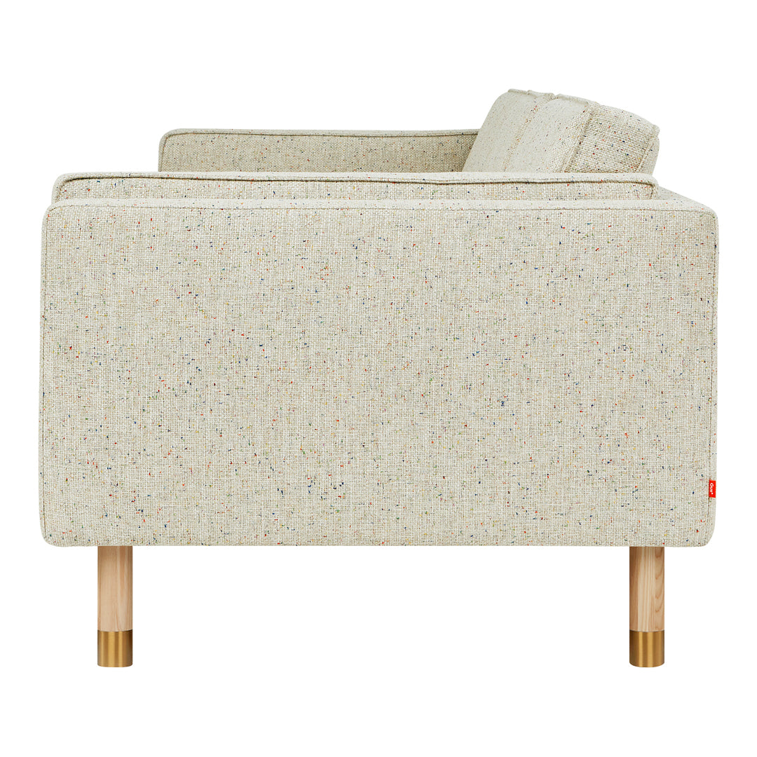 Light beige couch with textured fabric and subtle multicolor flecks, featuring wooden legs. Perfect for modern decor.