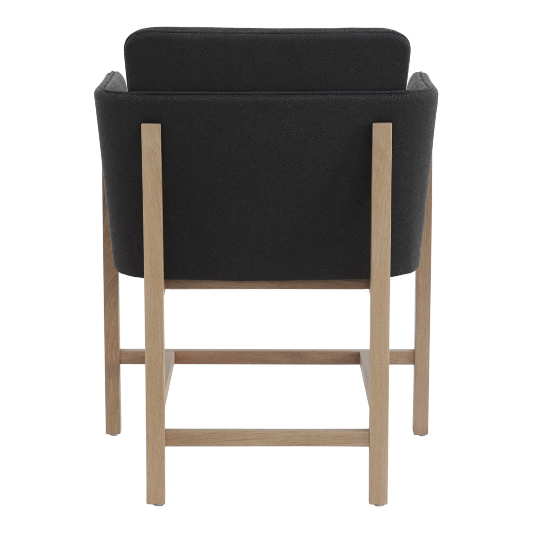 Black upholstered chair with a sleek, minimalist design and light wood legs, showcasing modern elegance.